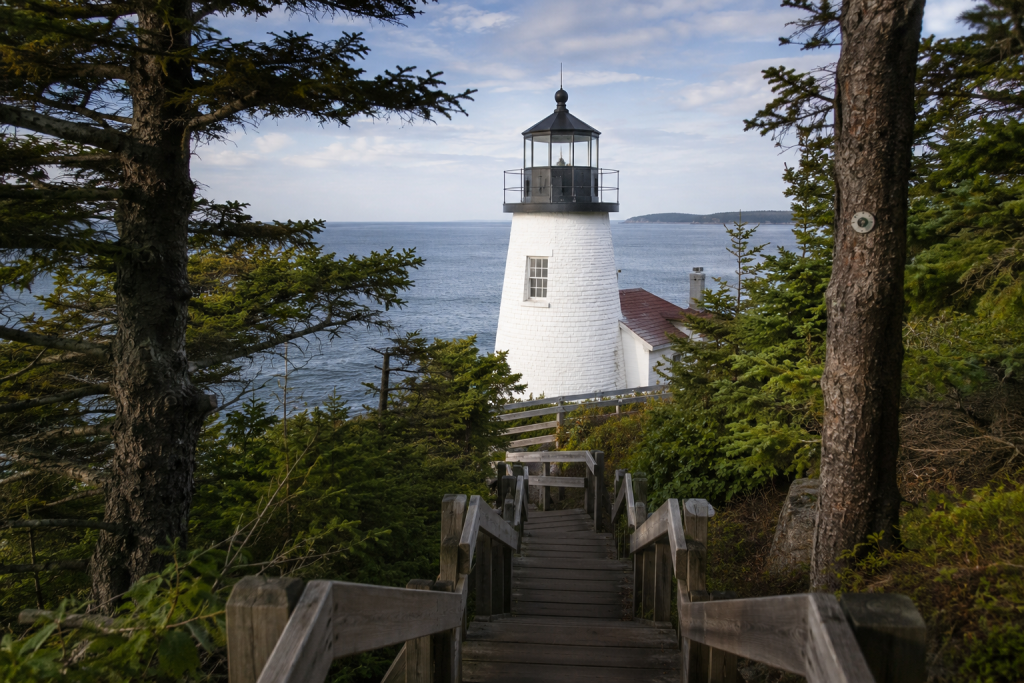 Owls Head Light through pine trees on Maine lighthouses road trip